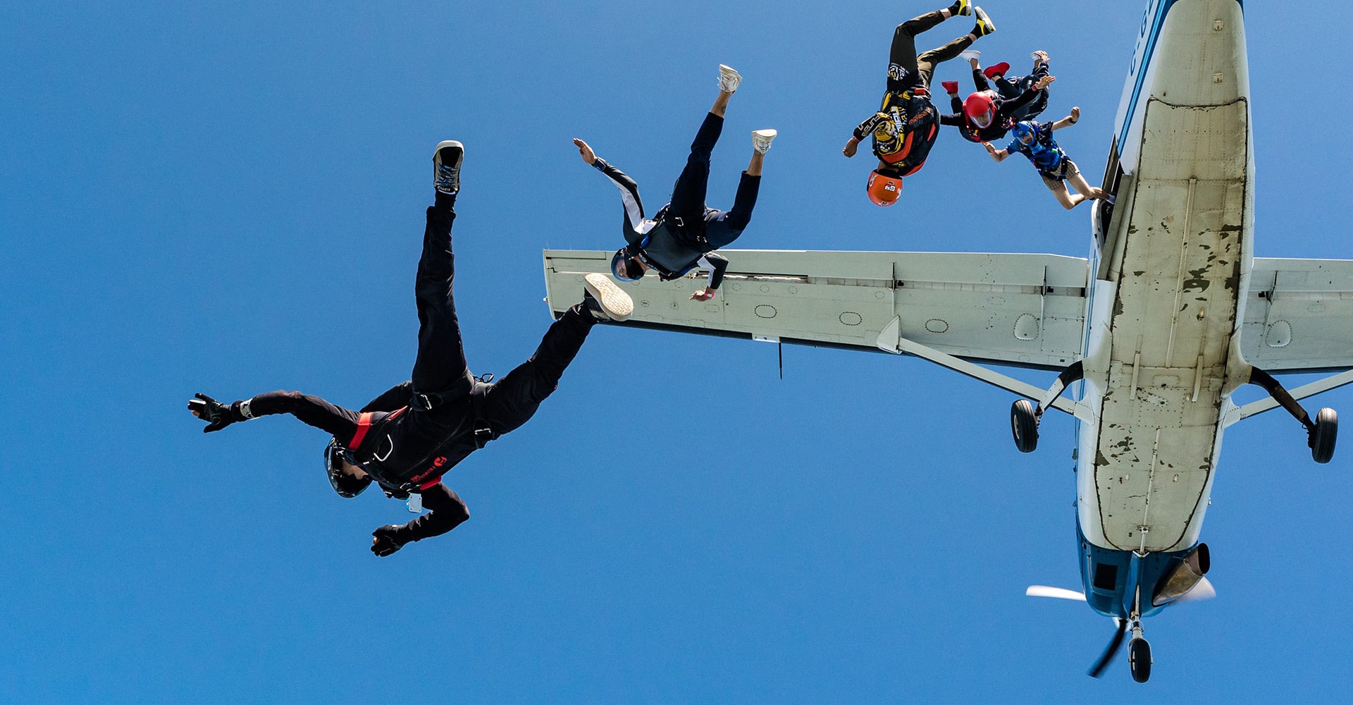 Skydivers jumping from a plane at 15,500 feet